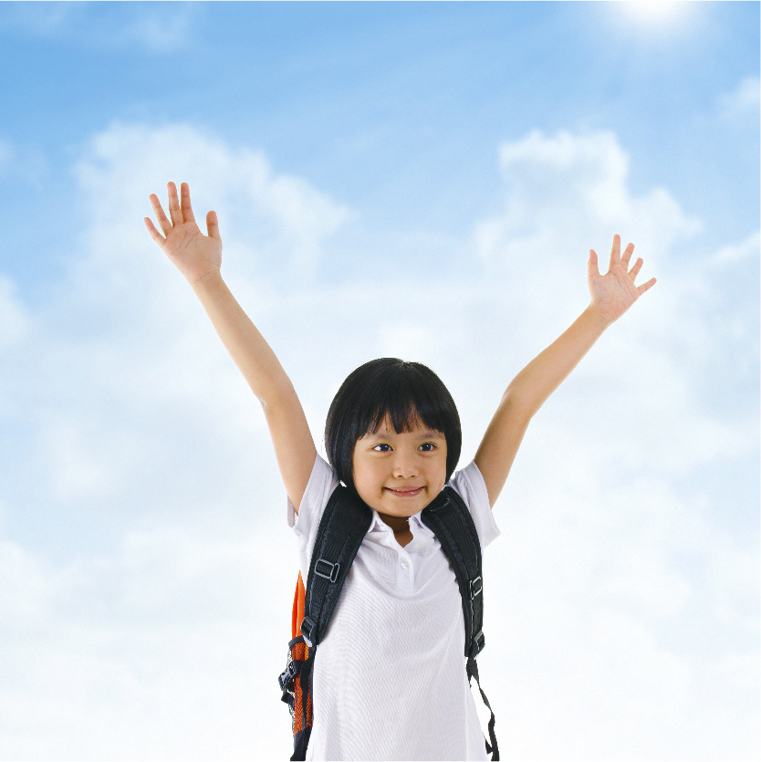 A cute little girl in a school uniform raises her hands in victory against a blue sky background.