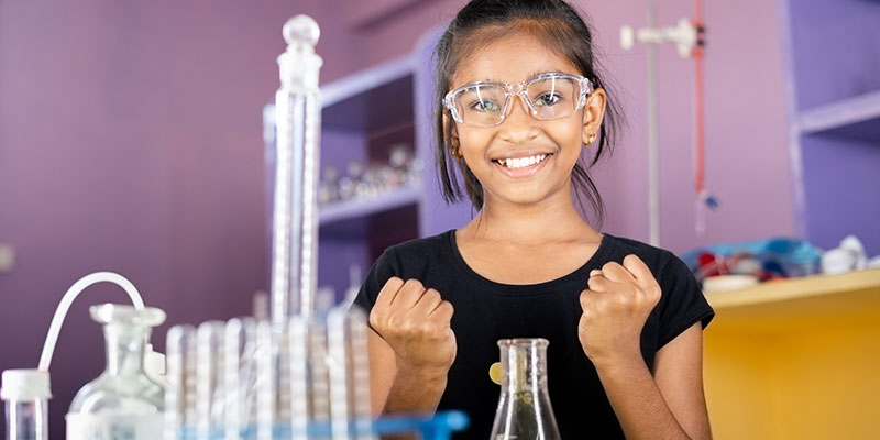 A student is excited about the success of her science experiment.