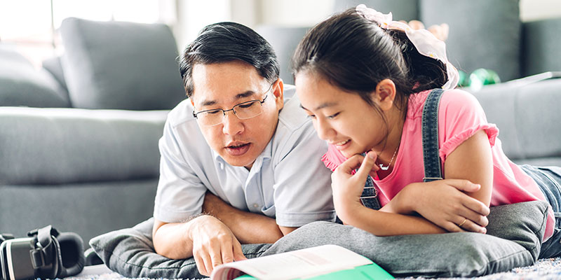 
Image of an Asian father teaching his daughter illustrates PSLE English Creative Writing With Expressive Emotions & Phrases.